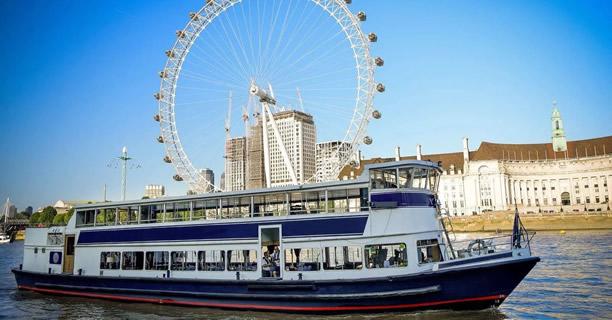 Golden Spirit party boat underneath the London Eye on the Thames